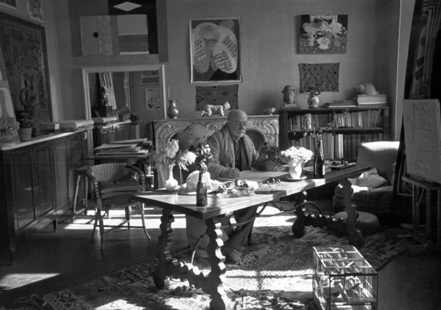 Photograph by Henri Cartier-Bresson (1908-2004) of Matisse with his collection of Kuba cloths and a Samoan tapa on the wall behind him, Villa La Rêve, Vence, 1944 *© Henri Cartier-Bresson/Magnum Photos *Courtesy Museum of Fine Arts, Boston